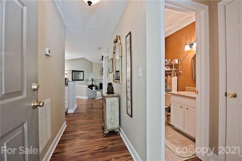 18809 Nautical Drive, Unit 302 Cornelius, NC 28031 - Photo 3 of 22 a view of a hallway with wooden floor and staircase