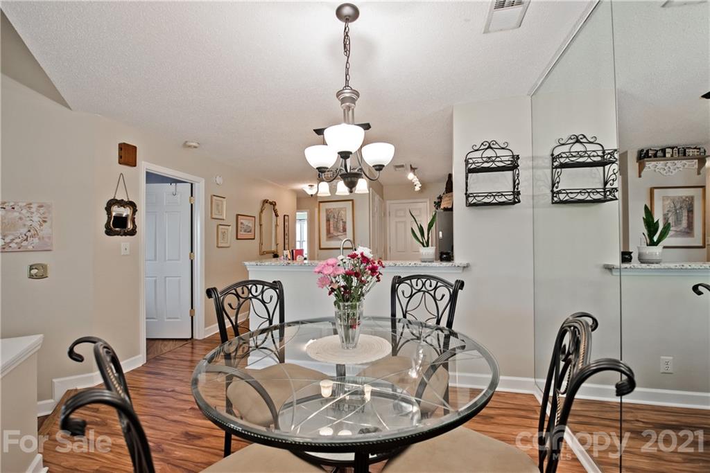 18809 Nautical Drive, Unit 302 Cornelius, NC 28031 - Photo 8 of 22 a dining room with furniture and chandelier