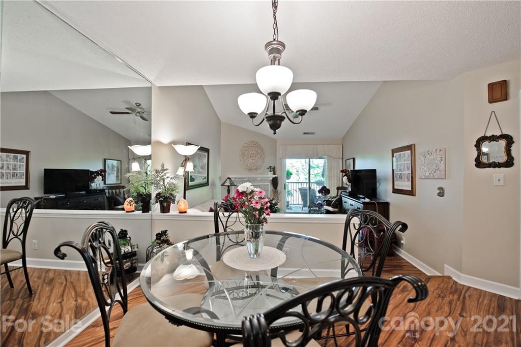 18809 Nautical Drive, Unit 302 Cornelius, NC 28031 - Photo 9 of 22 a view of a dining room with furniture and a chandelier