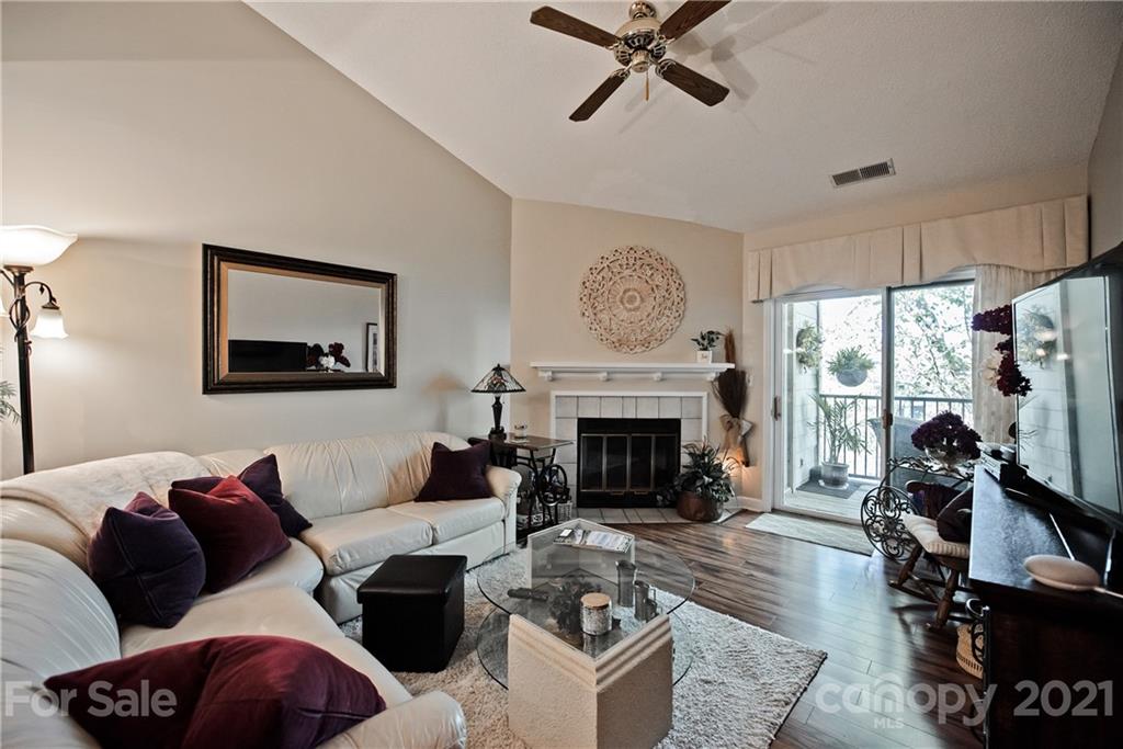 18809 Nautical Drive, Unit 302 Cornelius, NC 28031 - Photo 10 of 22 a living room with furniture a flat screen tv and a fireplace