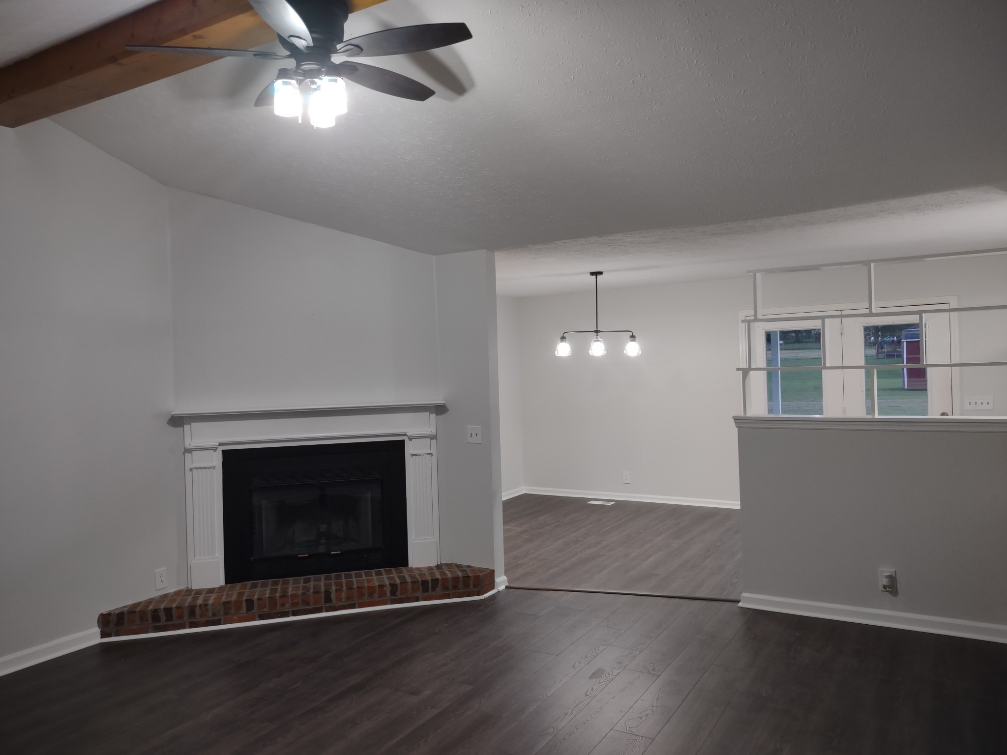 8951 Owens Chapel Road Springfield, TN 37172 - Photo 3 of 28 a view of an empty room with wooden floor and a fireplace