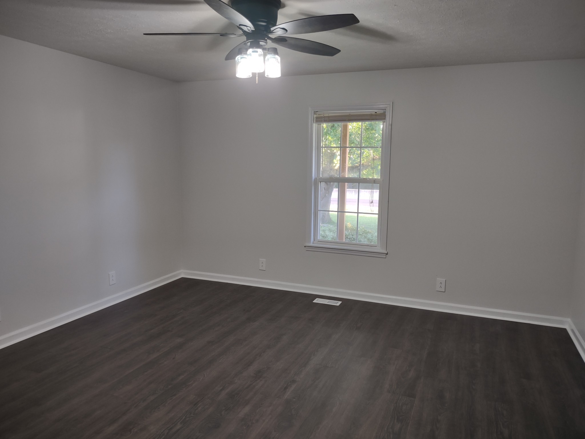 8951 Owens Chapel Road Springfield, TN 37172 - Photo 10 of 28 an empty room with wooden floor fan and windows
