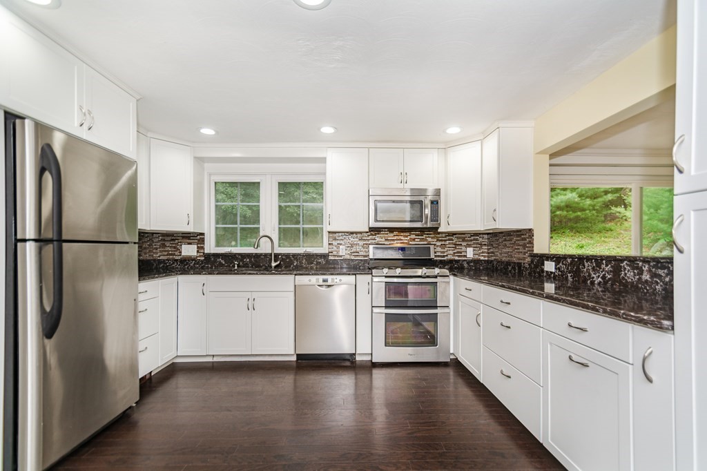10 Ruthellen Road Chelmsford, MA 01824 - Photo 8 of 35 a kitchen with stainless steel appliances granite countertop a refrigerator sink and cabinets