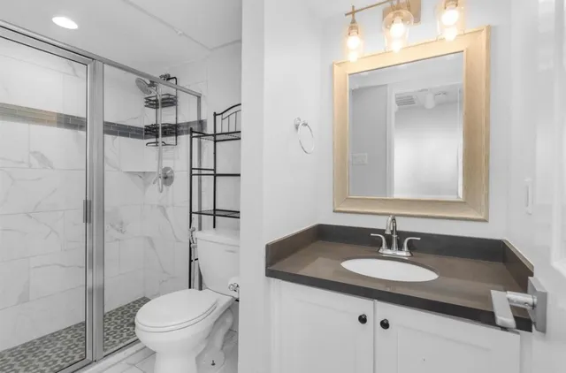 a bathroom with a sink toilet and shower