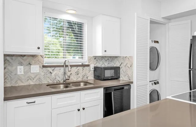 a kitchen with white cabinets and a fireplace