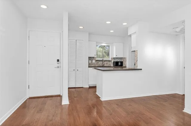 a view of kitchen with kitchen island microwave and stove