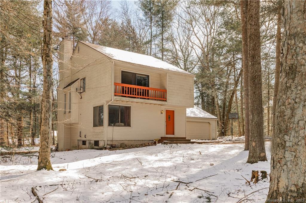 a view of a house with a yard covered in snow