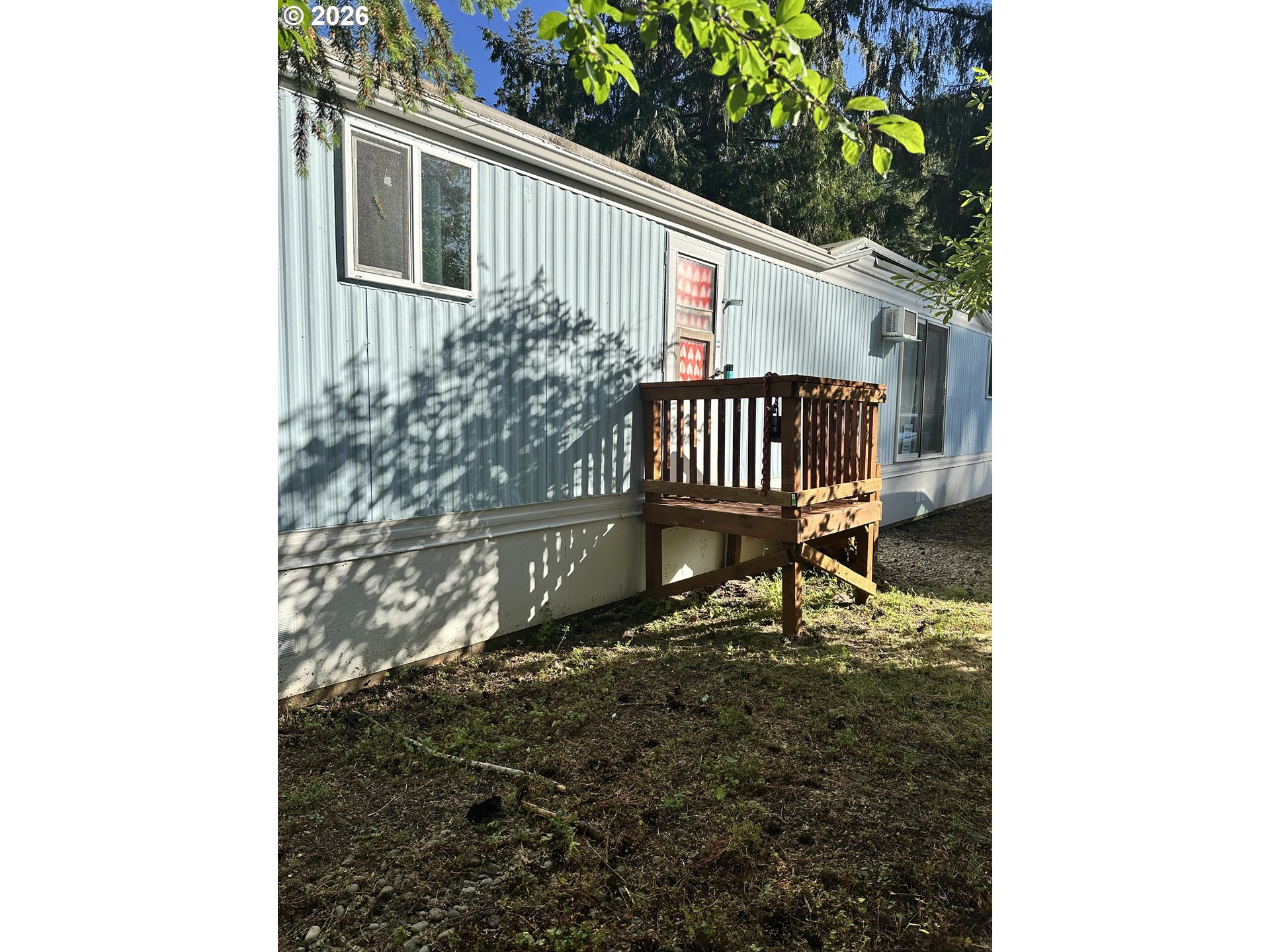 37635 Row River Road, Unit 7 Dorena, OR 97434 - Photo 4 of 27 a porch with a bench next to a yard