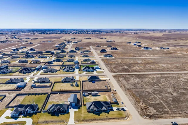 an aerial view of multiple houses with outdoor space