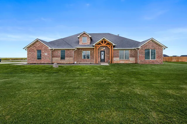 a front view of a house with a garden and deck