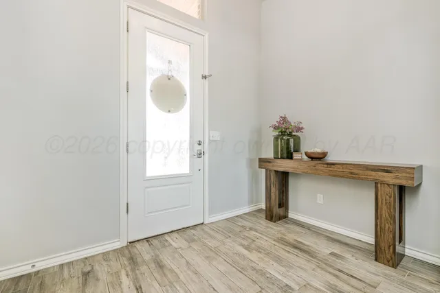 a view of an entryway with wooden floor
