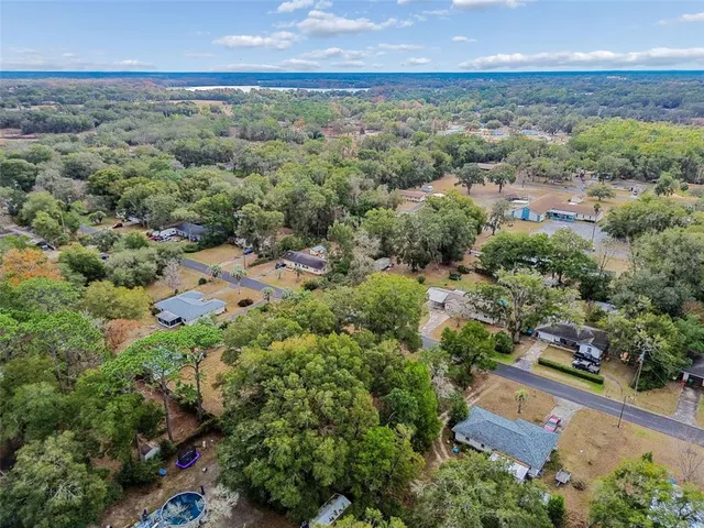an aerial view of a houses with a yard