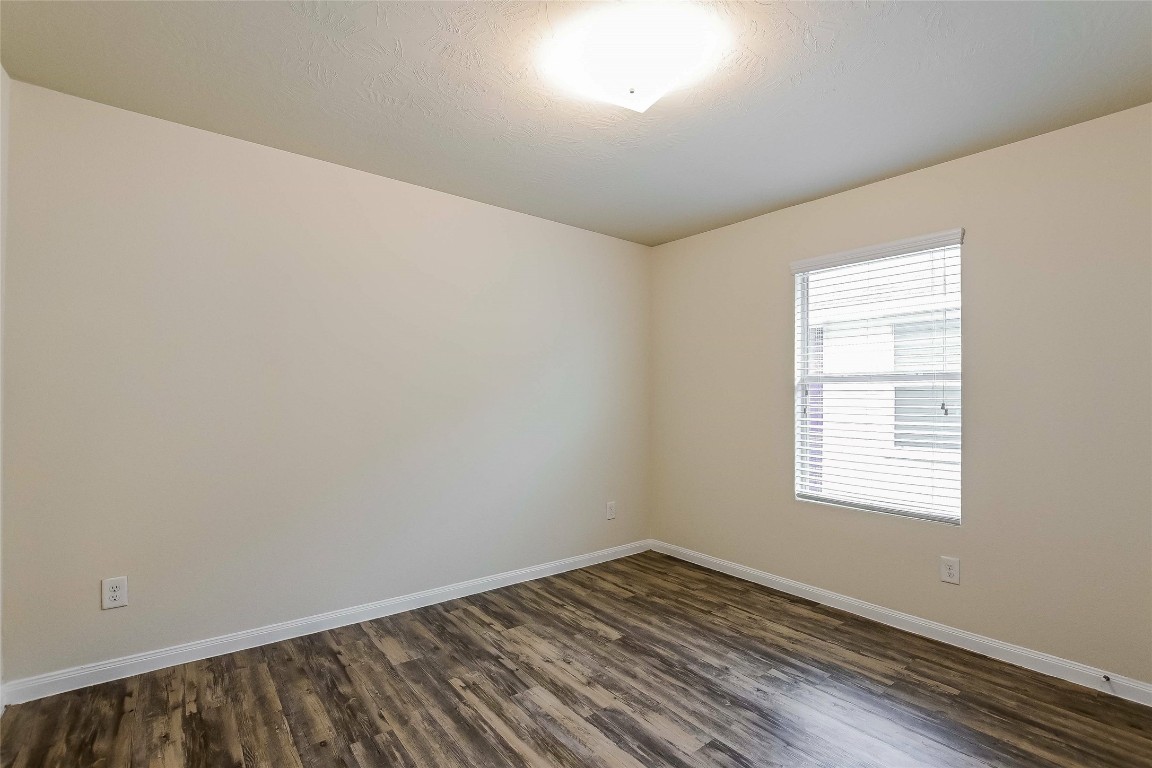 5506 Paiges Way Katy, TX 77449 - Photo 14 of 17 an empty room with wooden floor and windows