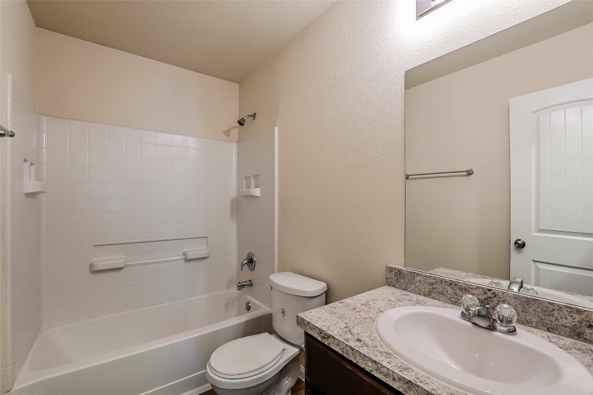 5506 Paiges Way Katy, TX 77449 - Photo 17 of 17 a bathroom with a granite countertop sink toilet and shower