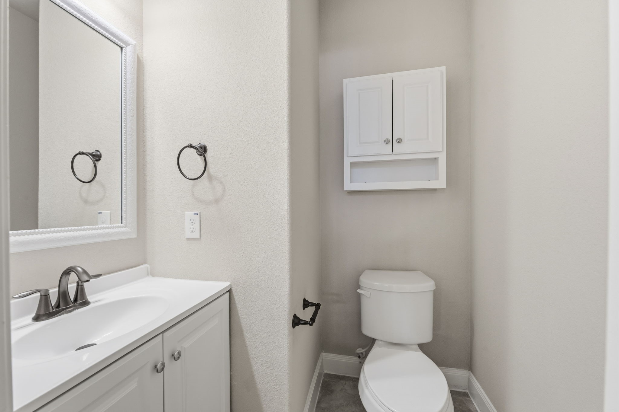 25210 Gaddis Oaks Drive Spring, TX 77389 - Photo 24 of 50 a bathroom with a toilet sink and mirror