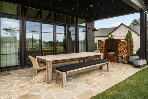 a outdoor space with a large window and furniture