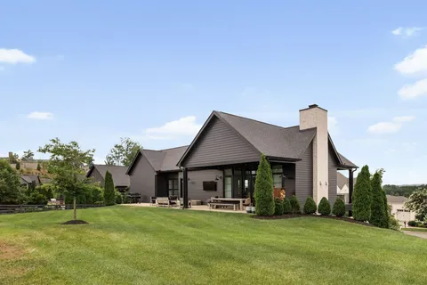 a front view of a house with a garden and porch