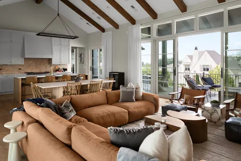a living room with furniture a rug and a chandelier