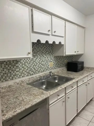 a kitchen with a sink and cabinets