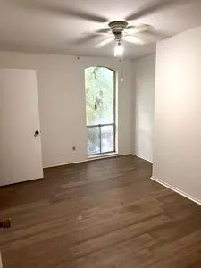an empty room with wooden floor and closet