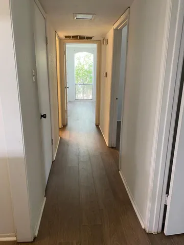 a bathroom with a granite countertop sink a toilet and a mirror