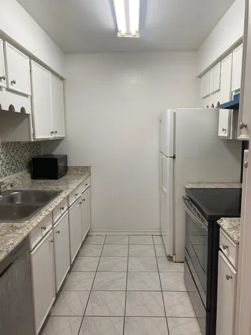 a kitchen with a stove and a refrigerator