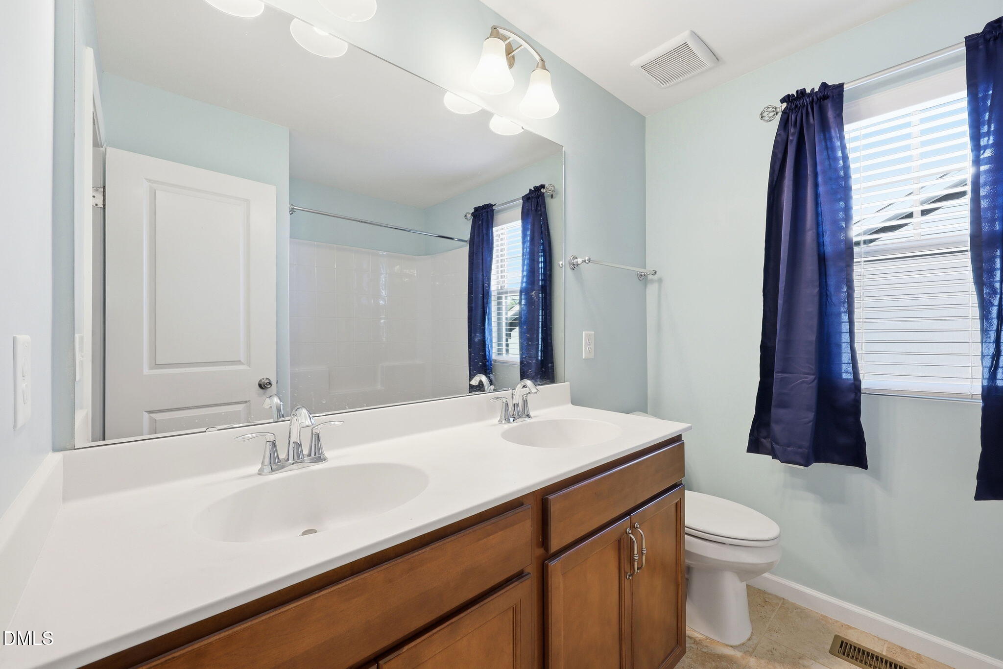 1808 Austin Rdg Parkway Wake Forest, NC 27587 - Photo 28 of 57 a bathroom with a sink a toilet a mirror and shower