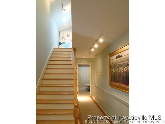 155 Longleaf Road Southern Pines, NC 28387 - Photo 15 of 24 a view of a hallway with wooden floor and a bathroom