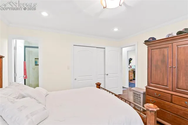 a bedroom with a bed and a large mirror