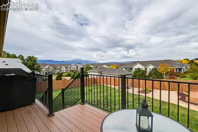 a view of a balcony with wooden floor and fence