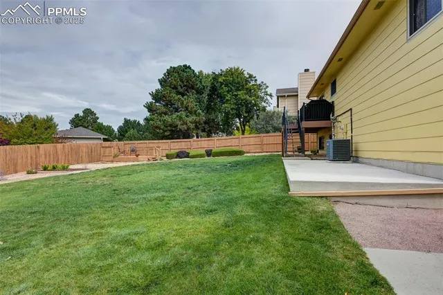 a front view of house with yard and trees