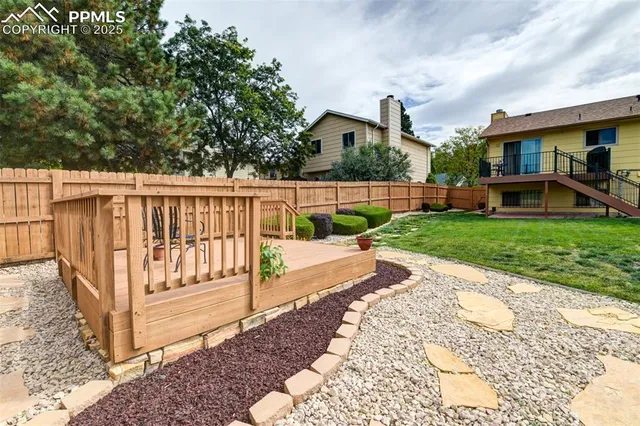 a view of backyard with a garden and stairs