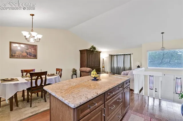 a room with a table chairs and wooden floor