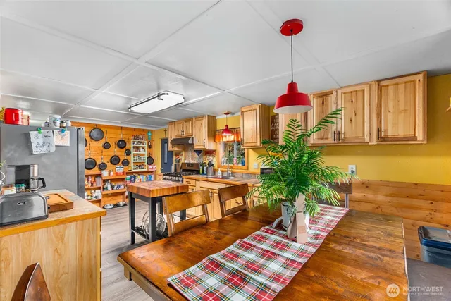 a kitchen with stainless steel appliances granite countertop a sink a stove and a wooden cabinets
