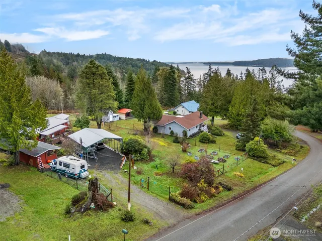an aerial view of a house with garden space and street view