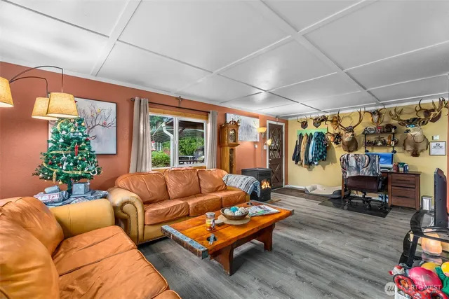 a living room with furniture a window and wooden floor