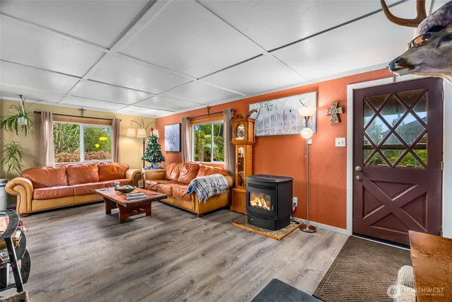 a kitchen with stainless steel appliances granite countertop a table chairs and a refrigerator