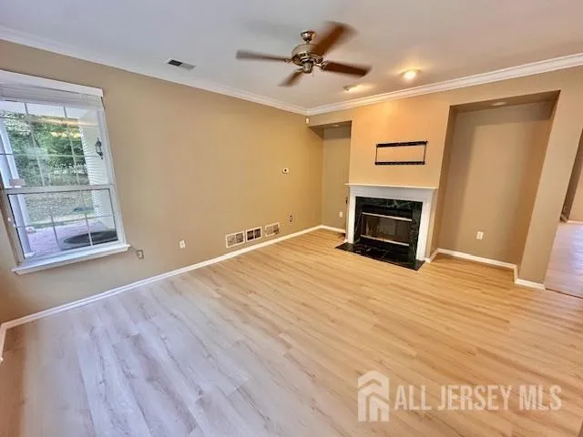 a big room with wooden floor and a ceiling fan