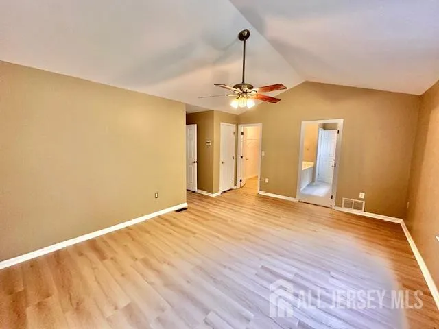 a spacious bathroom with a double vanity sink a mirror and a bathtub