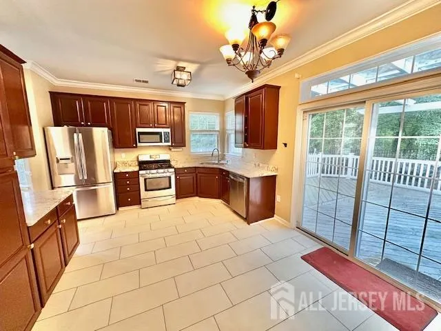 a large white kitchen with cabinets