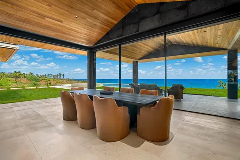 a view of swimming pool with a table and chairs under an umbrella