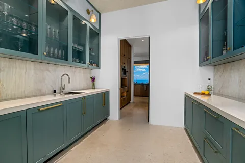 a kitchen with stainless steel appliances a sink stove and cabinets