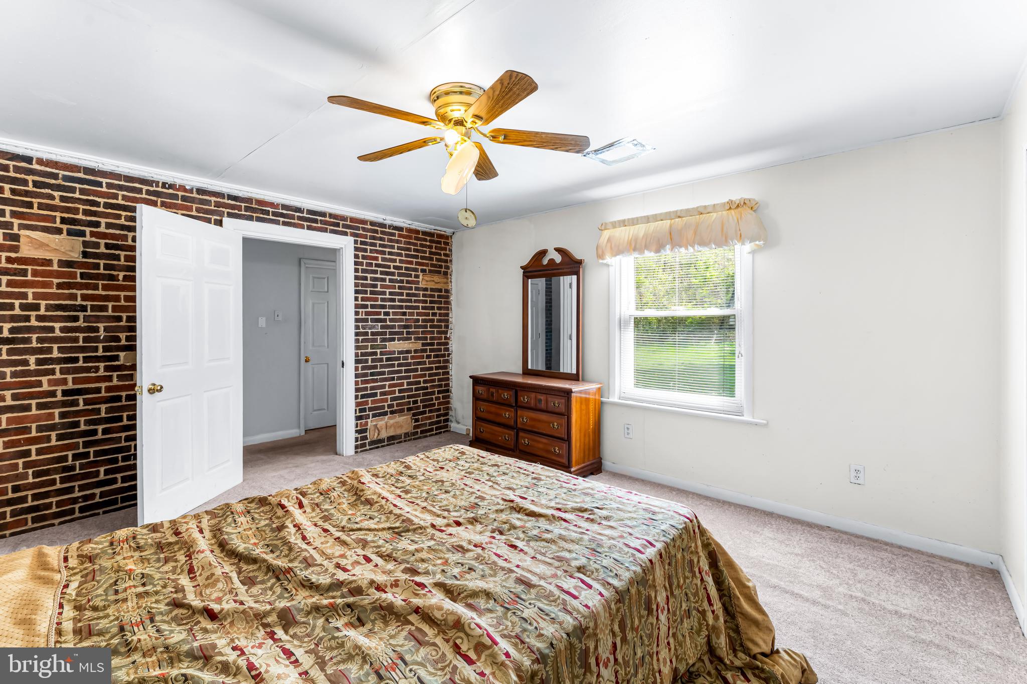 1112 Owens Road Oxon Hill, MD 20745 - Photo 23 of 30 a bedroom with a bed and a chandelier
