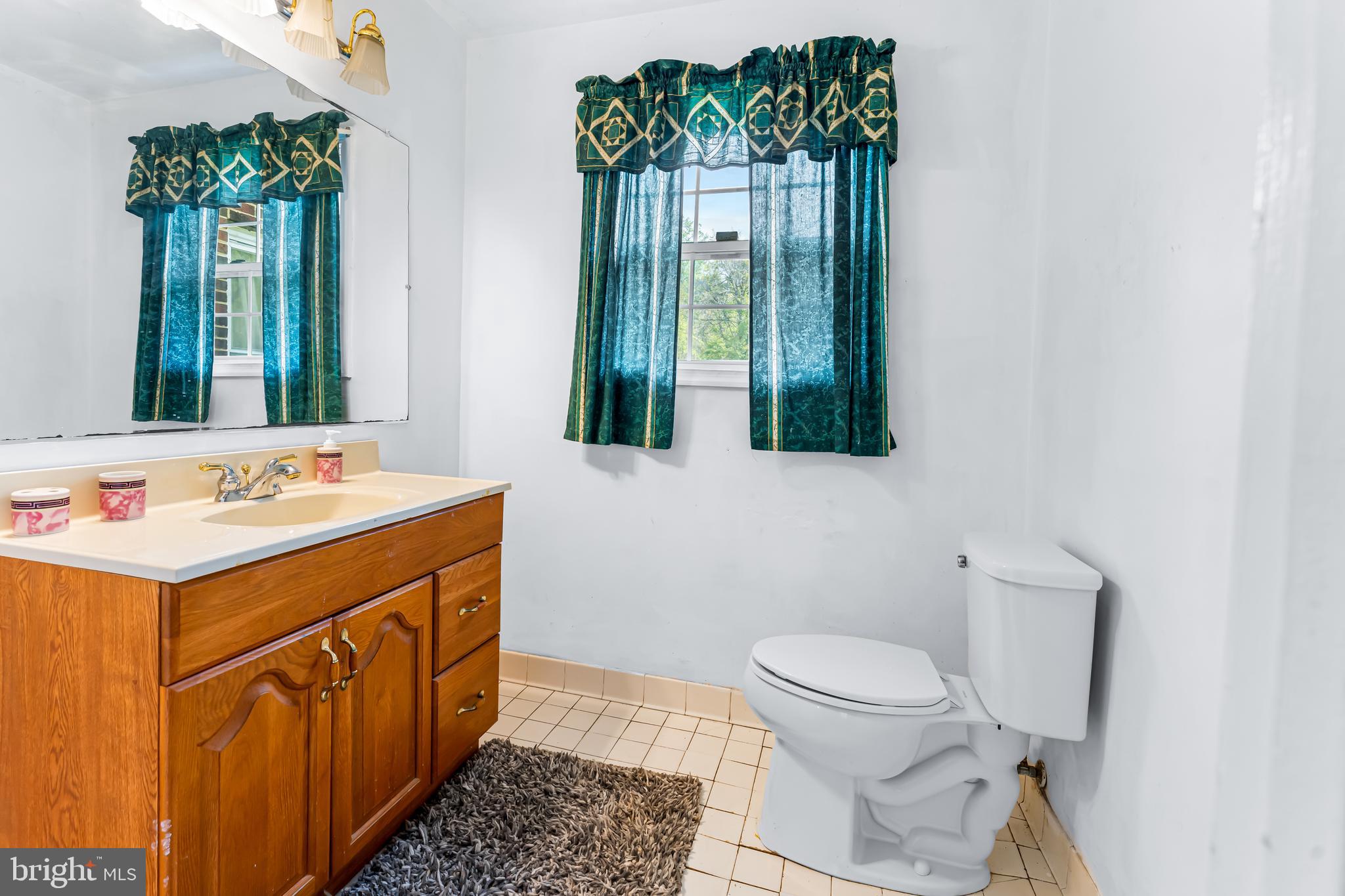 1112 Owens Road Oxon Hill, MD 20745 - Photo 26 of 30 a bathroom with a sink a toilet and mirror