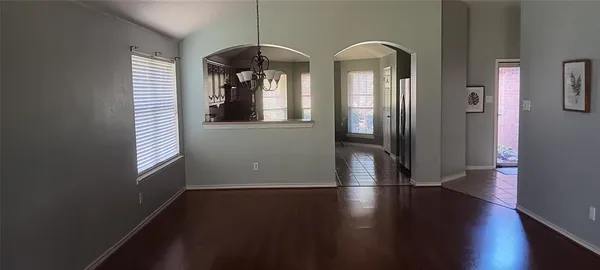 a view of a room with wooden floor and windows