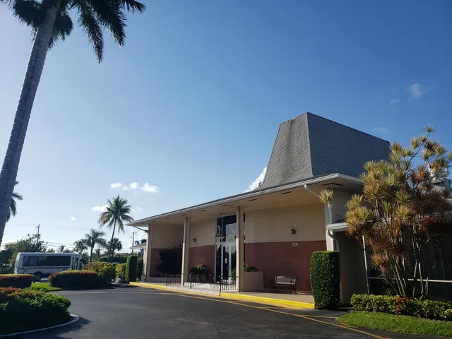 a view of a swimming pool with a patio and a yard