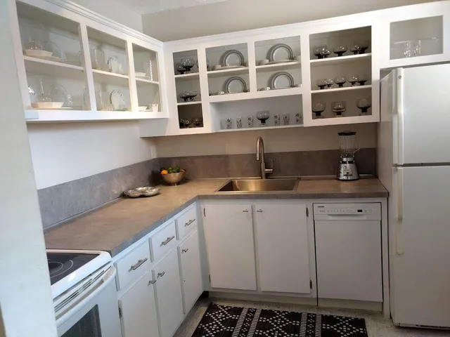 a kitchen with cabinets and window