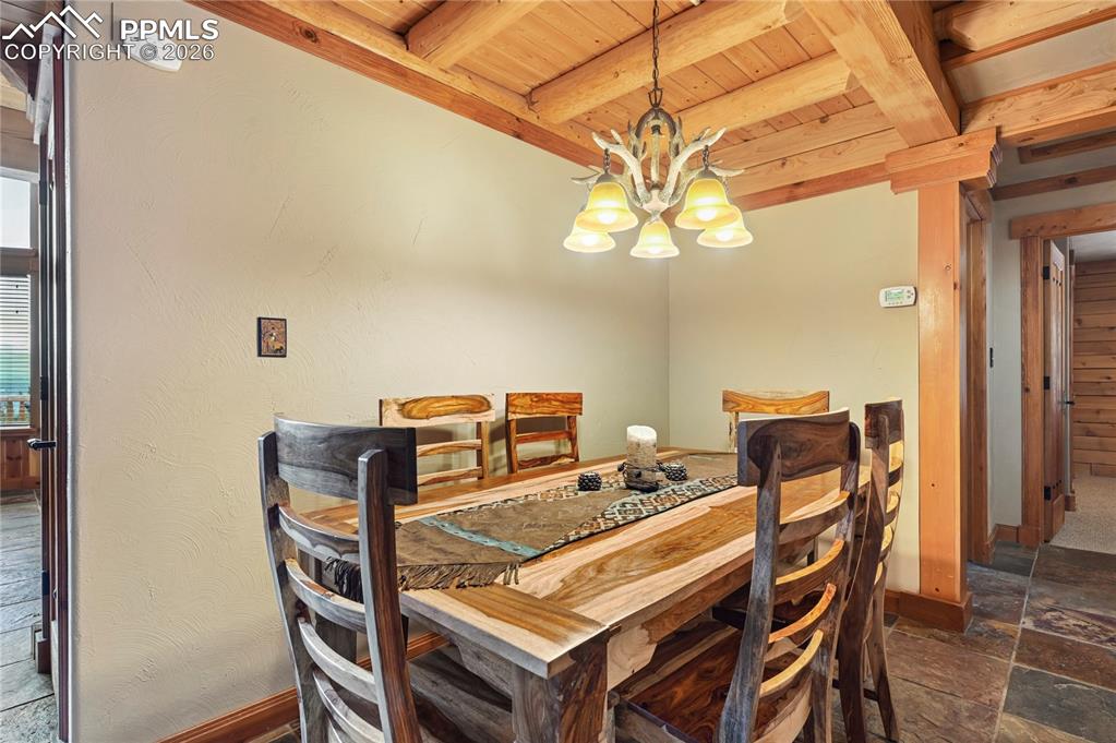 3613 Trail Creek Road Florissant, CO 80816 - Photo 17 of 43 a view of a dining room with furniture and a chandelier