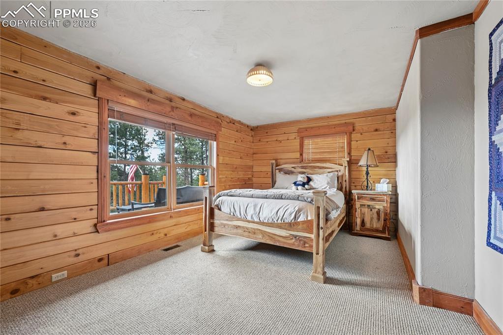 3613 Trail Creek Road Florissant, CO 80816 - Photo 20 of 43 a bed sitting in a room next to a window