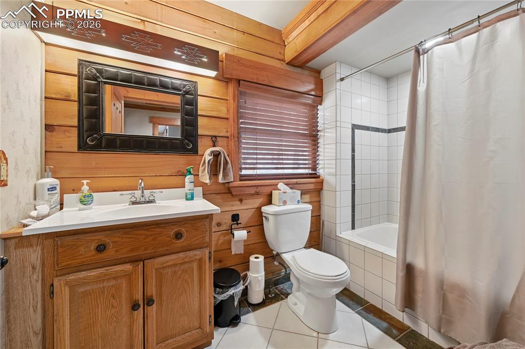 3613 Trail Creek Road Florissant, CO 80816 - Photo 22 of 43 a bathroom with a granite countertop sink toilet a mirror and shower